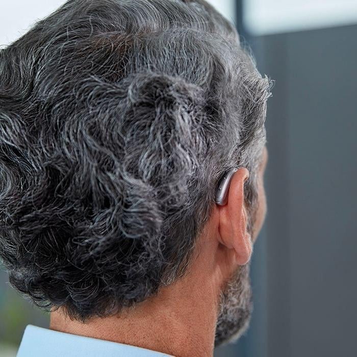 Signia hearing aid behind a man's ear