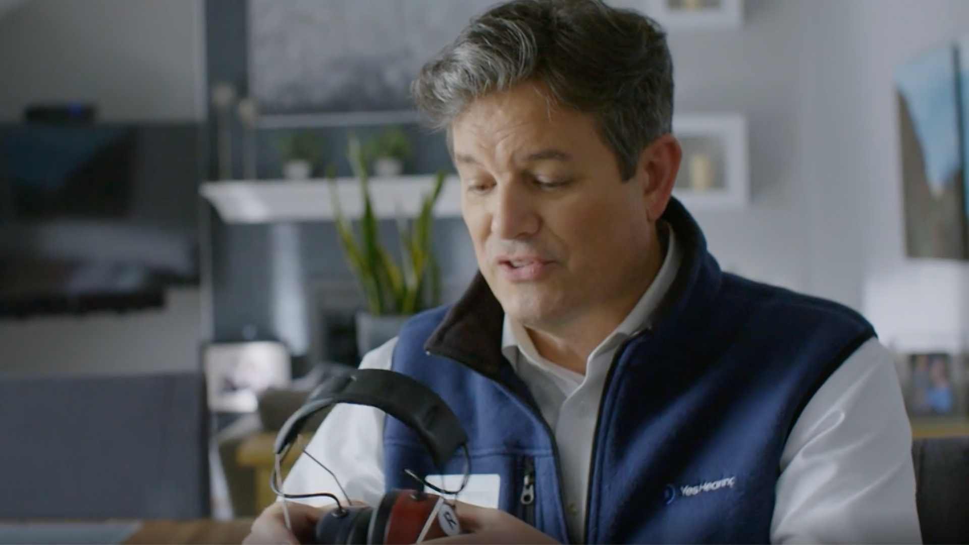 Audiologist administering a hearing test in a customer's home