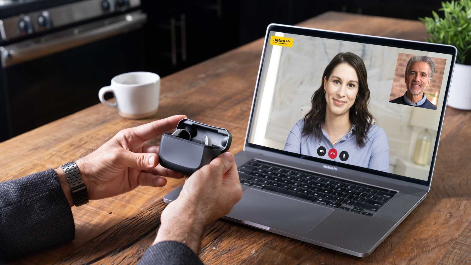 Man on a telehealth video call to set up his new hearing aids